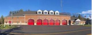 Brick fire station with 6 red garage doors
